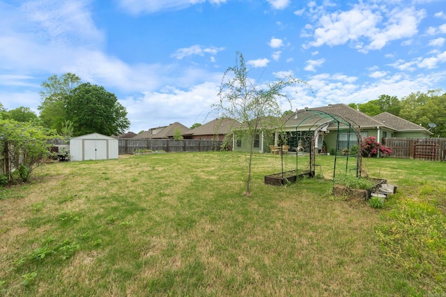 view of yard with a fenced backyard, an outbuilding, and a storage shed