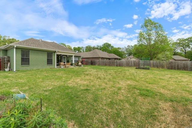 view of yard featuring a patio area and a fenced backyard