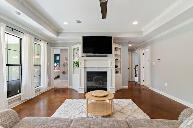living area with a glass covered fireplace, baseboards, ornamental molding, visible vents, and recessed lighting