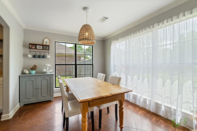 dining space with baseboards, visible vents, and crown molding