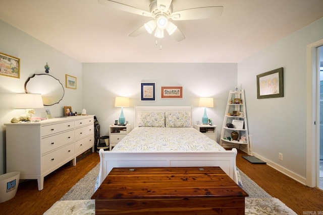 bedroom with a ceiling fan, baseboards, and dark wood-type flooring