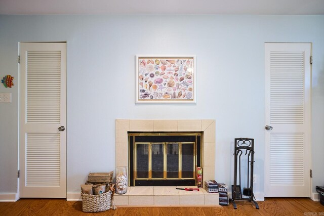 room details with a tiled fireplace and wood finished floors