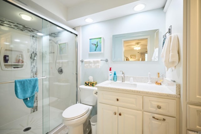 full bathroom featuring a shower stall, toilet, and vanity