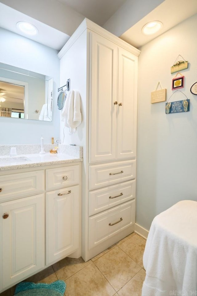 bathroom with baseboards, tile patterned floors, and vanity