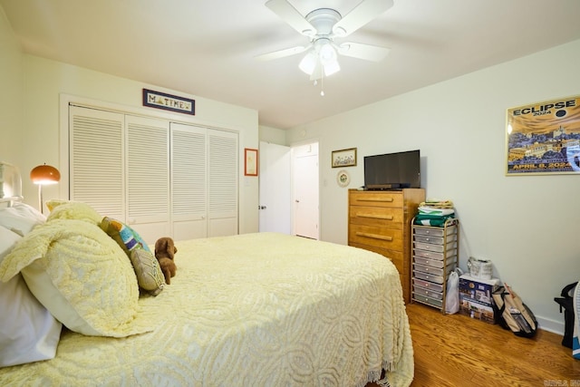 bedroom with wood finished floors, a closet, and ceiling fan