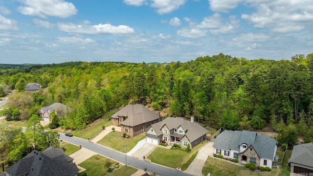birds eye view of property with a forest view and a residential view