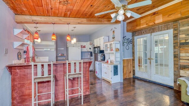 123 Hickory Rd, Hardy, AR 72542 - kitchen featuring wood walls, french doors, freestanding refrigerator, black microwave, and dark wood-style flooring