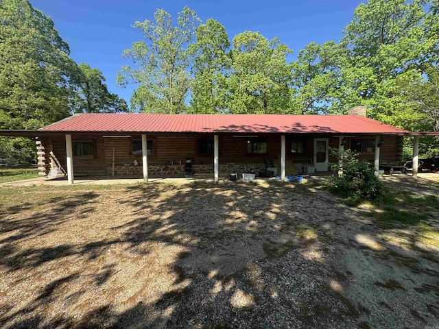 118 Jb Logan Circle Highway, De Queen, AR 71832 - back of house featuring a chimney, metal roof, log siding, and covered porch