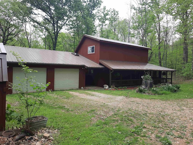 3986 Oak Grove Loop, Mountain View, AR 72560 - view of front of property featuring an attached garage, driveway, and metal roof