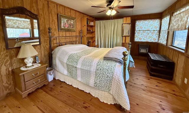 3986 Oak Grove Loop, Mountain View, AR 72560 - bedroom featuring heating unit, wooden walls, and light wood-style floors