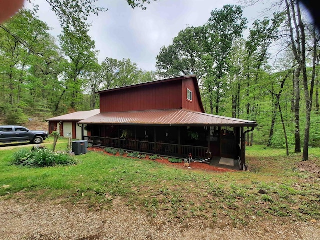 3986 Oak Grove Loop, Mountain View, AR 72560 - exterior space with a garage, central air condition unit, and metal roof