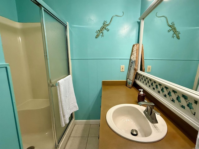 3986 Oak Grove Loop, Mountain View, AR 72560 - bathroom with tile patterned flooring, a wainscoted wall, a sink, and a shower stall