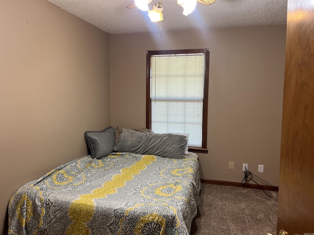 3223 Canal Dr, White Hall, AR 71602 - bedroom featuring a textured ceiling, carpet flooring, baseboards, and ceiling fan