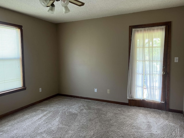 3223 Canal Dr, White Hall, AR 71602 - empty room featuring a textured ceiling, a wealth of natural light, carpet flooring, and ceiling fan