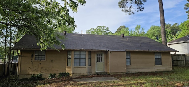 back of house featuring fence