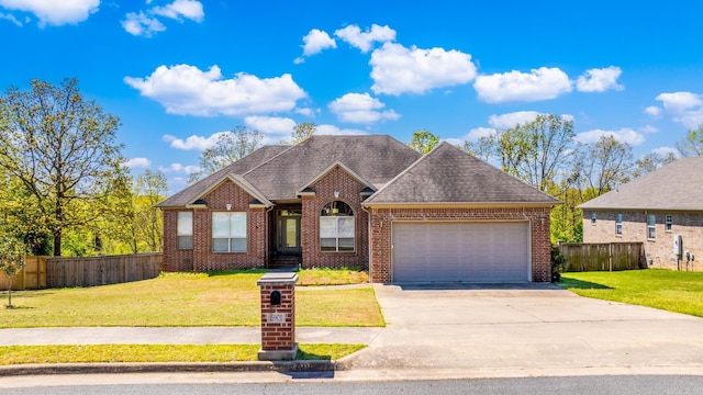 view of front of house featuring brick siding, an attached garage, and fence