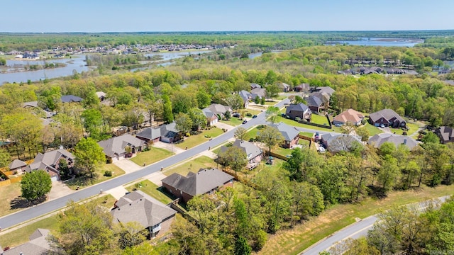 bird's eye view with a forest view, a water view, and a residential view