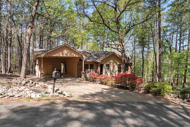 view of front of house featuring driveway and an attached carport