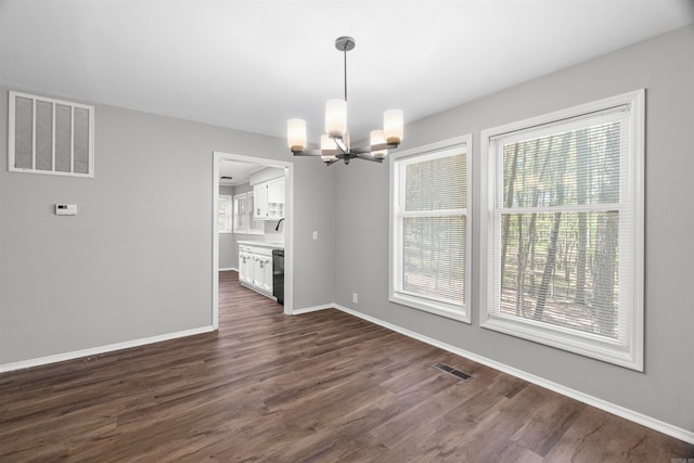unfurnished dining area with an inviting chandelier, visible vents, and plenty of natural light