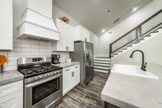 93 Pocahontas Ln, Greers Ferry, AR 72067 - kitchen with custom exhaust hood, a sink, appliances with stainless steel finishes, dark wood-type flooring, and visible vents