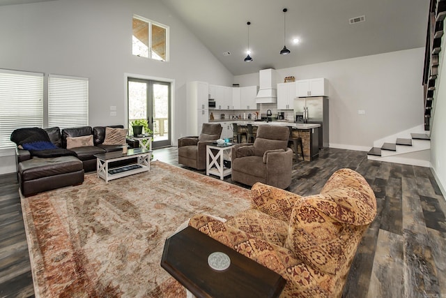 93 Pocahontas Ln, Greers Ferry, AR 72067 - living room featuring dark wood finished floors, visible vents, stairs, baseboards, and high vaulted ceiling