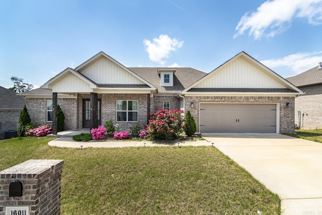 craftsman-style home featuring concrete driveway, a front lawn, brick siding, and a garage