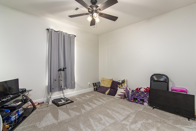 playroom with baseboards, visible vents, carpet floors, and ceiling fan