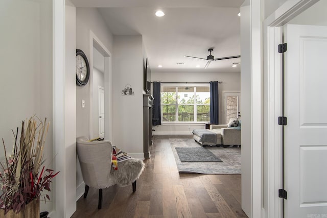 hallway with baseboards, dark wood-style flooring, and recessed lighting