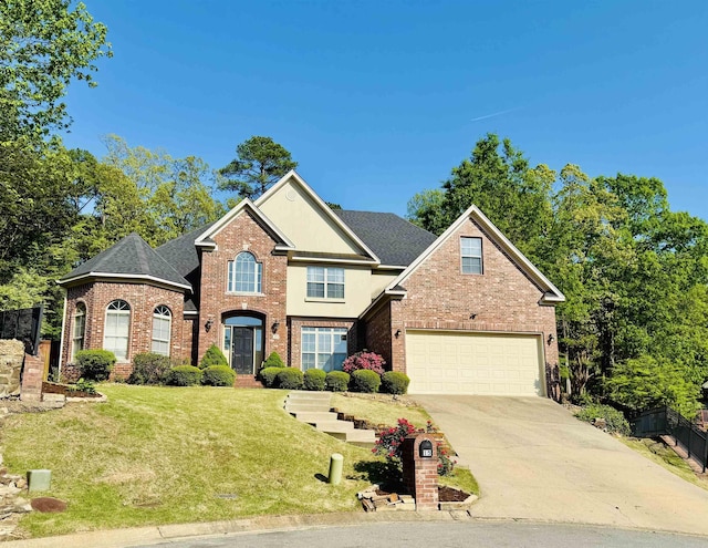 15 Wellington Woods Ct, Little Rock, AR 72211 - view of front of property featuring roof with shingles, a front lawn, driveway, brick siding, and an attached garage