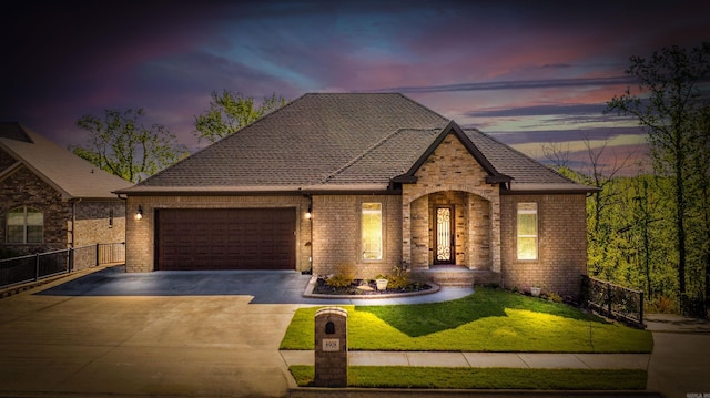 8908 Stillwater Rd, Sherwood, AR 72120 - french country style house with fence, an attached garage, driveway, brick siding, and a front yard