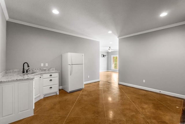 8908 Stillwater Rd, Sherwood, AR 72120 - kitchen featuring a sink, freestanding refrigerator, recessed lighting, ceiling fan, and ornamental molding