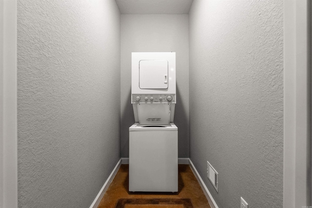 8908 Stillwater Rd, Sherwood, AR 72120 - laundry room featuring stacked washer / drying machine, a textured wall, baseboards, and laundry area