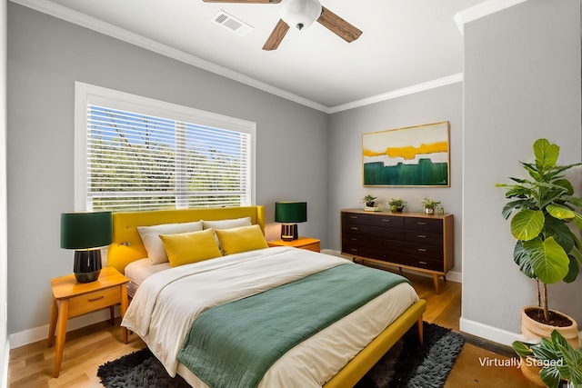 8908 Stillwater Rd, Sherwood, AR 72120 - bedroom with baseboards, wood finished floors, visible vents, and crown molding
