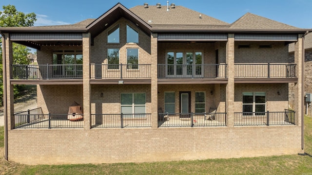 8908 Stillwater Rd, Sherwood, AR 72120 - rear view of house with brick siding, roof with shingles, and a balcony