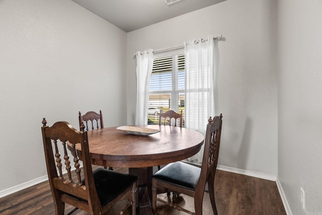 dining space with baseboards and dark wood-style flooring