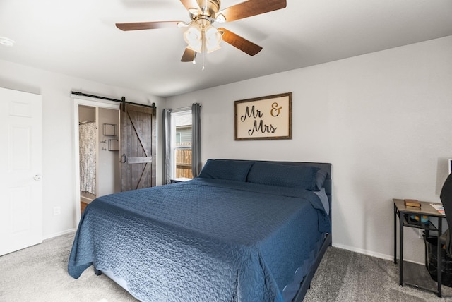 bedroom featuring a barn door, carpet floors, ceiling fan, and baseboards