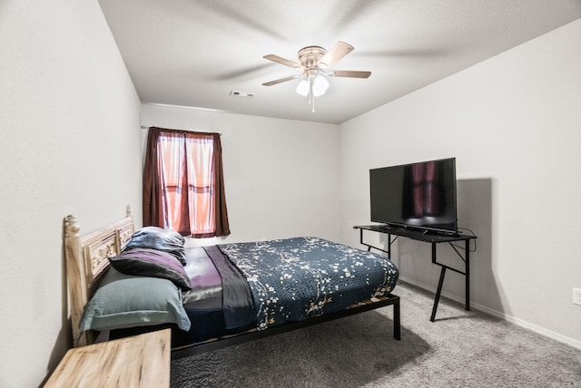 bedroom featuring baseboards, a ceiling fan, visible vents, and carpet