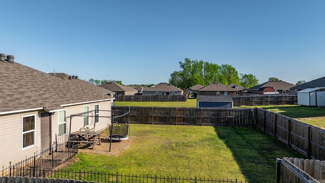 view of yard with a fenced backyard and a residential view