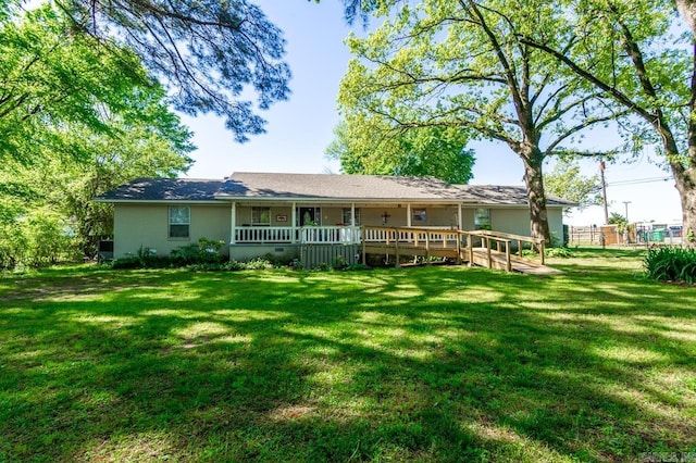 back of property with fence, a lawn, and a wooden deck