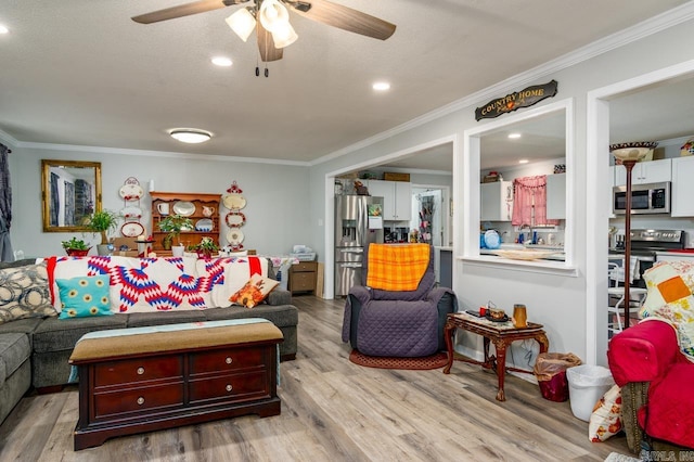 living room featuring wood finished floors, crown molding, and ceiling fan