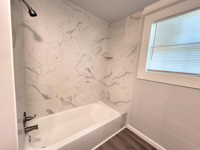 full bath featuring wood finished floors and bathing tub / shower combination