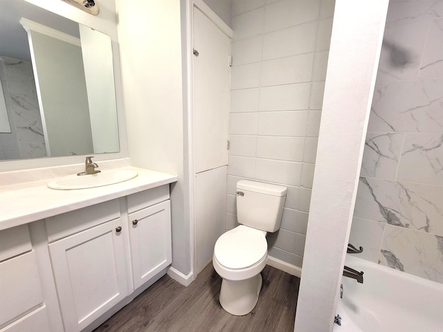 bathroom with shower / washtub combination, toilet, vanity, and wood finished floors
