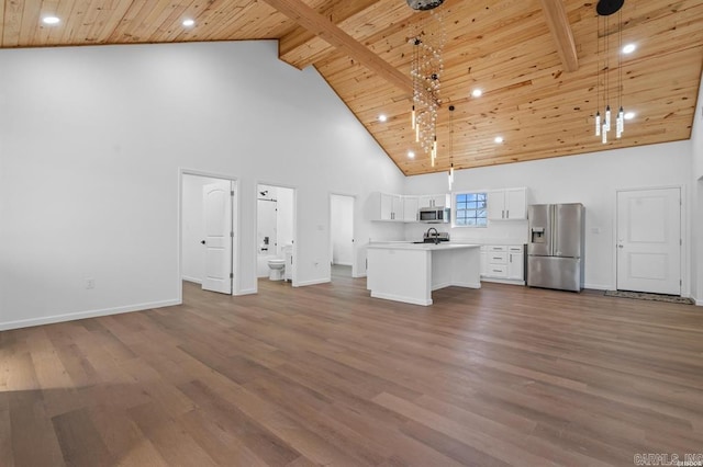 unfurnished living room featuring baseboards, wood ceiling, and high vaulted ceiling
