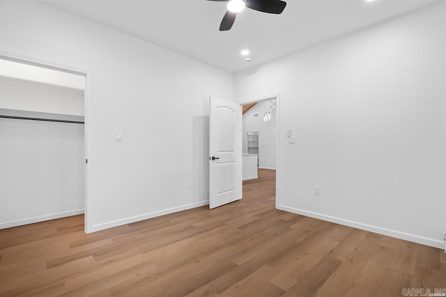 unfurnished bedroom with recessed lighting, a closet, light wood finished floors, and baseboards