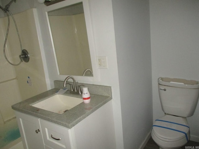 bathroom featuring toilet and vanity