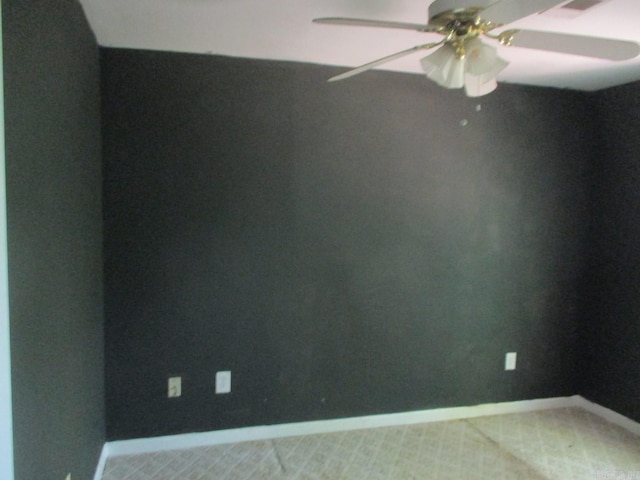 unfurnished room with baseboards and a ceiling fan