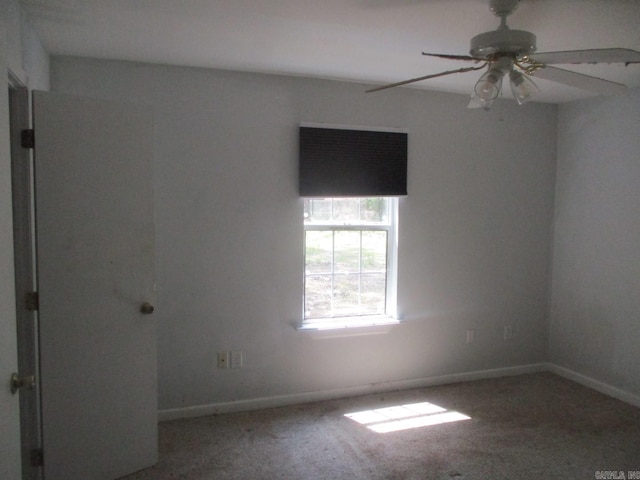 spare room featuring baseboards, a ceiling fan, and carpet flooring