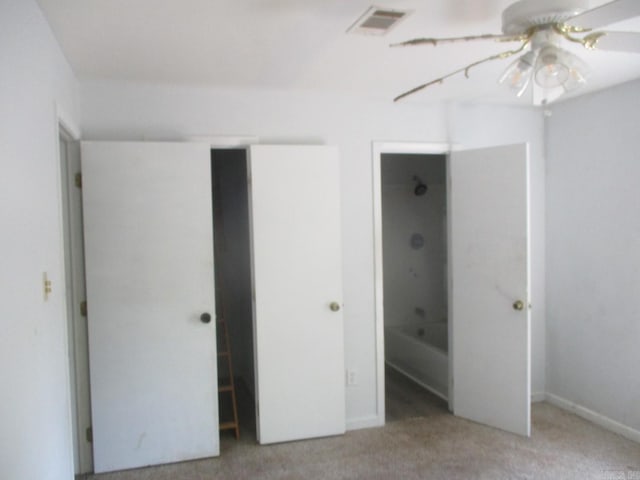 unfurnished bedroom featuring carpet and visible vents