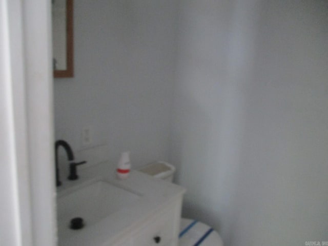 bathroom featuring toilet and a sink
