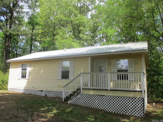 rear view of property with metal roof